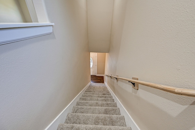 stairway featuring baseboards