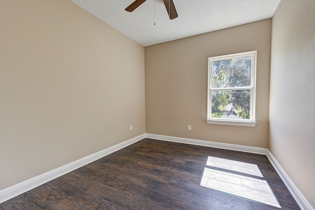 unfurnished room with dark wood-type flooring, baseboards, and ceiling fan