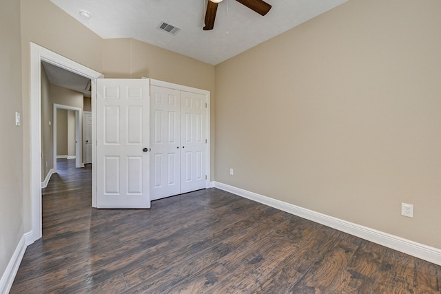 unfurnished bedroom featuring a ceiling fan, baseboards, visible vents, dark wood-style floors, and a closet