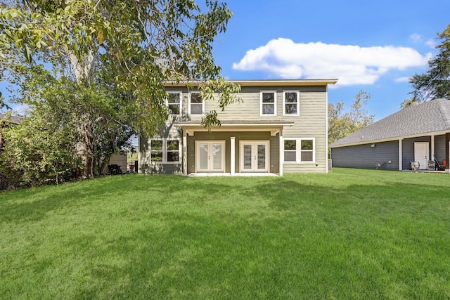rear view of house with a lawn and french doors