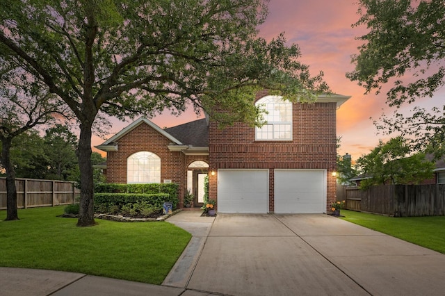 traditional-style house with concrete driveway, brick siding, fence, and a garage