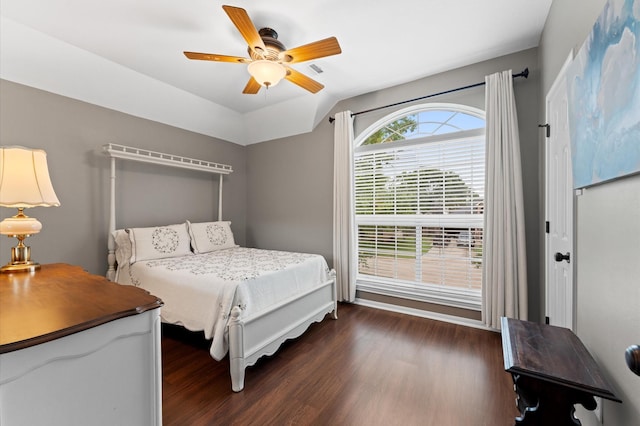 bedroom with ceiling fan, dark wood-style floors, and lofted ceiling