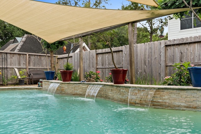 view of swimming pool with a fenced backyard