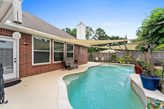 view of swimming pool with a fenced in pool, a patio, and a fenced backyard