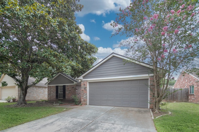 single story home featuring fence, a front lawn, brick siding, a garage, and concrete driveway