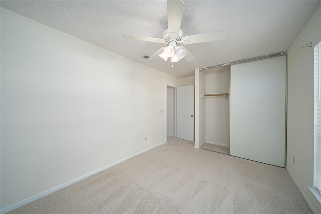 unfurnished bedroom featuring ceiling fan, light carpet, baseboards, visible vents, and a closet