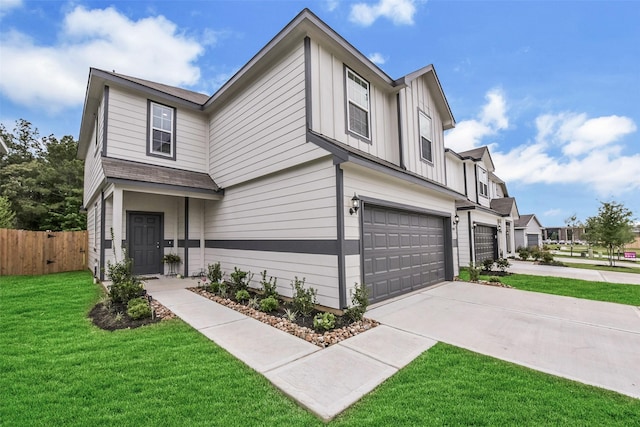 view of front of property with fence, a front yard, board and batten siding, an attached garage, and driveway