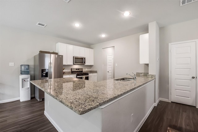 kitchen with baseboards, white cabinets, stainless steel appliances, and dark wood-style floors