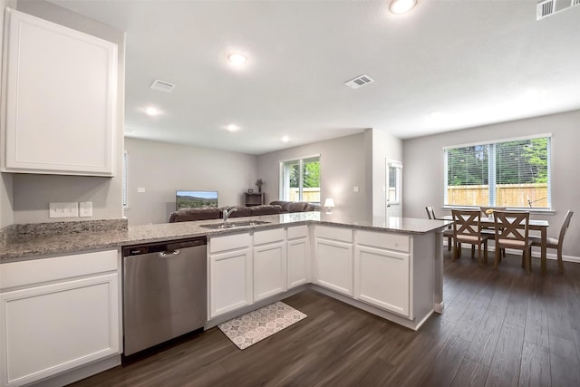 kitchen with a sink, dishwasher, a peninsula, dark wood-type flooring, and visible vents