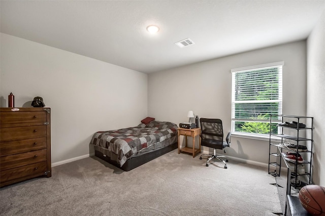 bedroom with carpet floors, baseboards, and visible vents