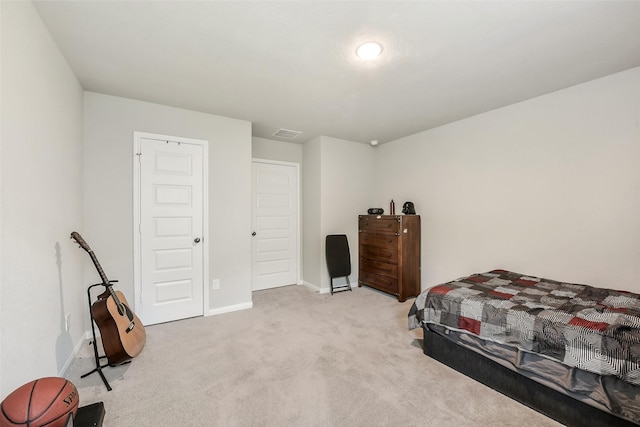 bedroom with light colored carpet, baseboards, and visible vents