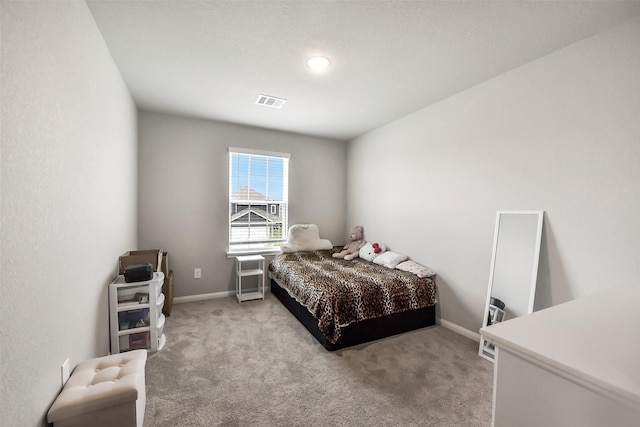 carpeted bedroom with visible vents and baseboards