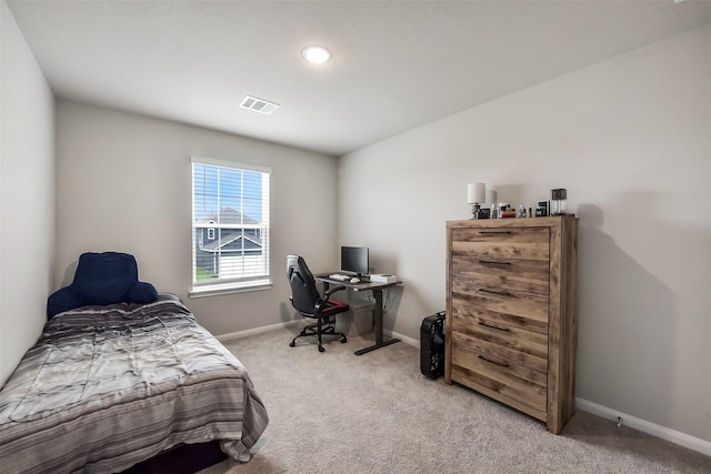 bedroom with visible vents, baseboards, and light carpet