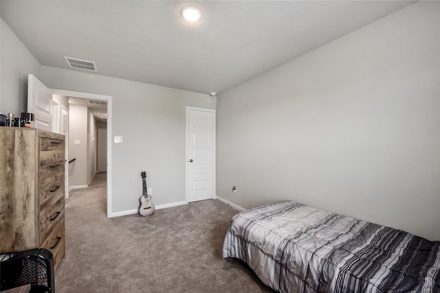 bedroom with baseboards, visible vents, and carpet