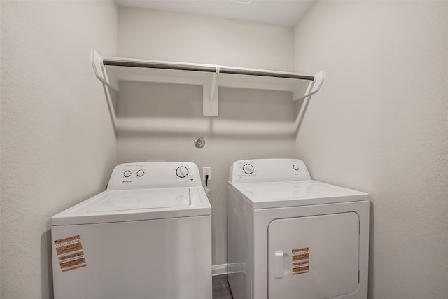 clothes washing area featuring laundry area and washing machine and clothes dryer