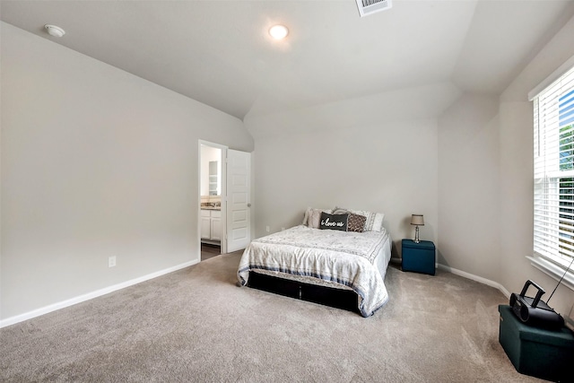 bedroom with baseboards, visible vents, lofted ceiling, and carpet