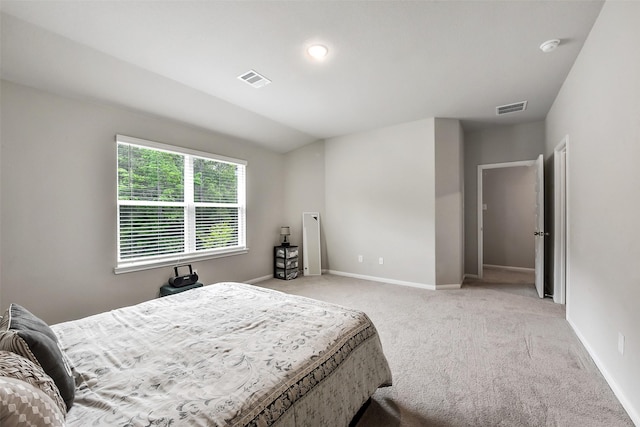 bedroom featuring baseboards, light carpet, and visible vents