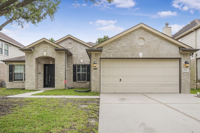 29634 Legends Line Dr, Spring, TX 77386 - view of front facade with an attached garage, driveway, and brick siding