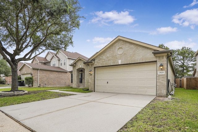 29634 Legends Line Dr, Spring, TX 77386 - view of front of house featuring brick siding, a garage, driveway, and a front yard