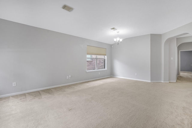29634 Legends Line Dr, Spring, TX 77386 - empty room with visible vents, arched walkways, a chandelier, and light carpet