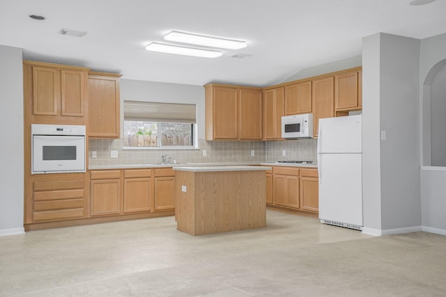 29634 Legends Line Dr, Spring, TX 77386 - kitchen featuring light countertops, decorative backsplash, a kitchen island, and white appliances