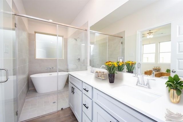 14519 Aston Pines Dr, Houston, TX 77032 - bathroom with a shower stall, a freestanding bath, and a sink