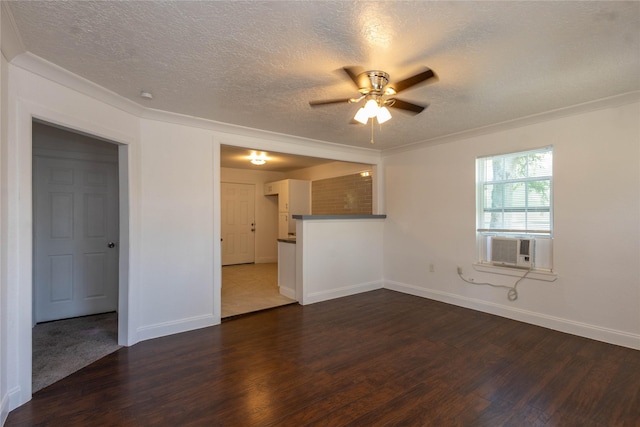 unfurnished living room with dark wood-type flooring, a ceiling fan, a textured ceiling, and crown molding