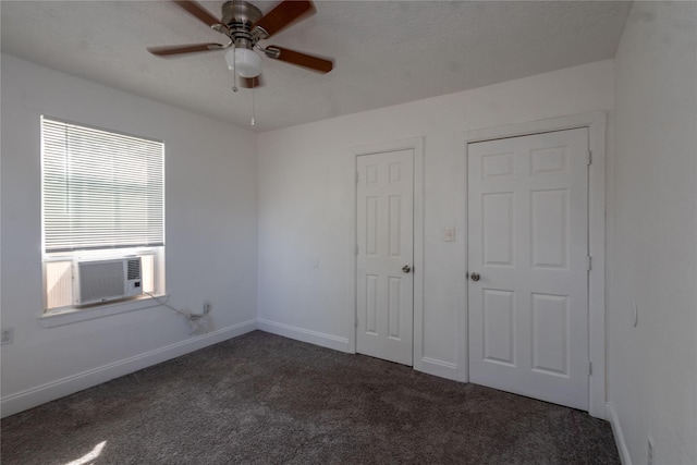 unfurnished bedroom featuring baseboards, ceiling fan, cooling unit, and carpet flooring