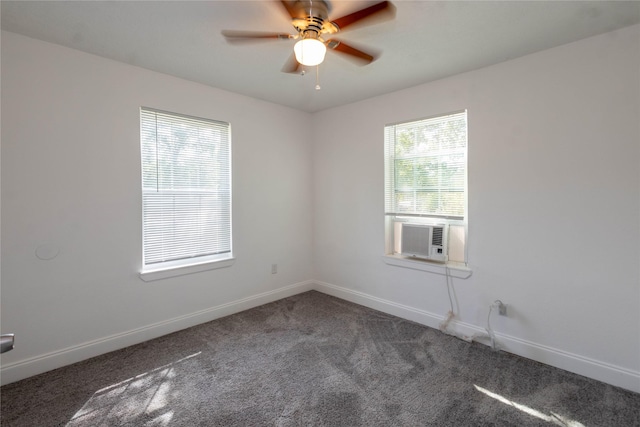 carpeted spare room featuring baseboards, ceiling fan, and cooling unit