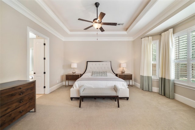 carpeted bedroom featuring crown molding, baseboards, visible vents, and a raised ceiling