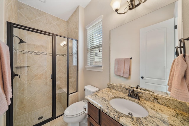 full bath with vanity, toilet, and a stall shower