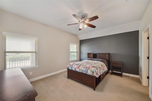 bedroom featuring baseboards, ceiling fan, and light carpet