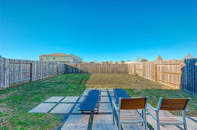 view of yard featuring a patio and a fenced backyard
