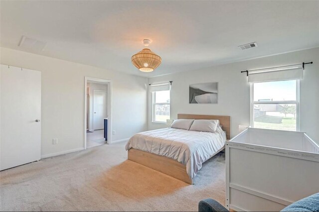 carpeted bedroom with baseboards and visible vents