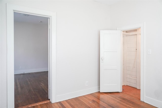 unfurnished room featuring baseboards and wood finished floors
