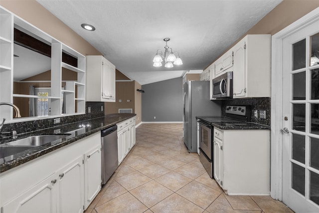 kitchen featuring stainless steel appliances, open shelves, white cabinetry, and a sink