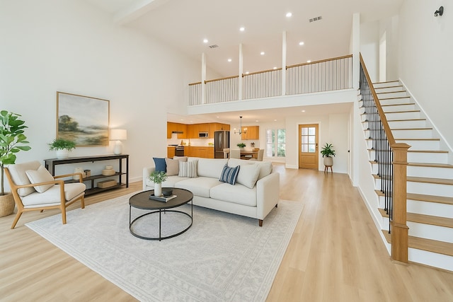7906 Duffield Ln, Houston, TX 77071 - living area featuring high vaulted ceiling, light wood finished floors, stairs, recessed lighting, and beam ceiling