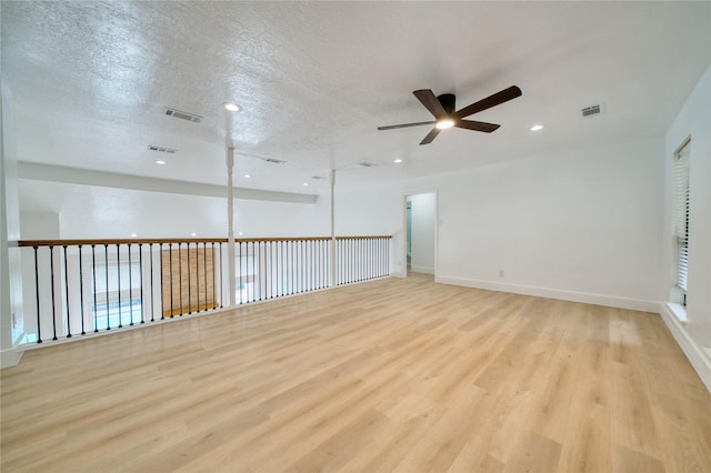 7906 Duffield Ln, Houston, TX 77071 - unfurnished room with ceiling fan, light wood finished floors, recessed lighting, a textured ceiling, and baseboards
