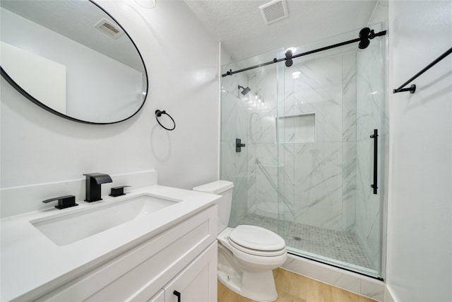 bathroom with a marble finish shower, toilet, and visible vents