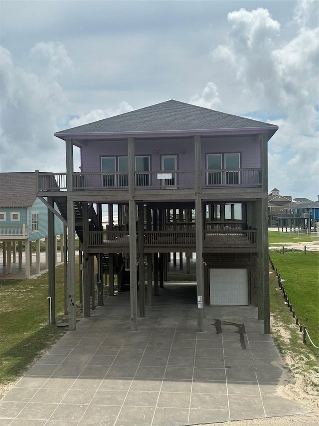 view of home's community featuring a garage, a yard, driveway, and a carport