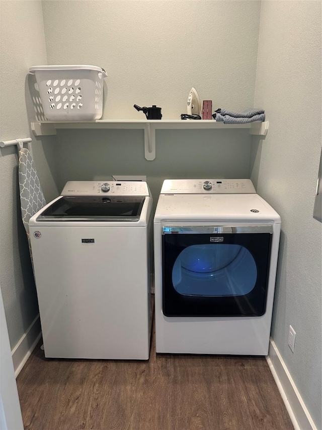 laundry area with independent washer and dryer, laundry area, baseboards, and wood finished floors
