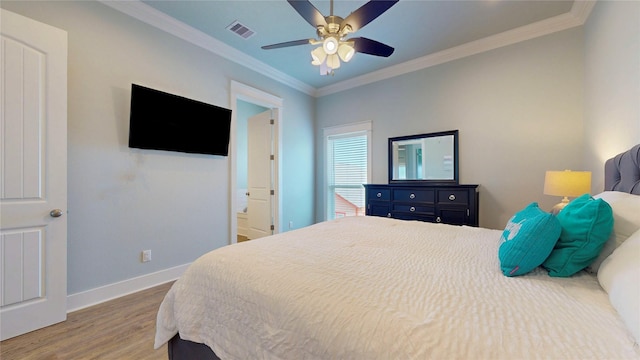 975 S Stingaree, Crystal Beach, TX 77650 - bedroom with wood finished floors, baseboards, ornamental molding, and ceiling fan