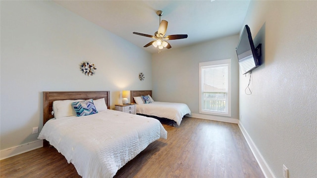 975 S Stingaree, Crystal Beach, TX 77650 - bedroom with wood finished floors, baseboards, and a ceiling fan