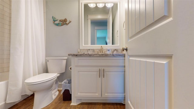 975 S Stingaree, Crystal Beach, TX 77650 - full bath featuring toilet, wood finished floors, vanity, and shower / bathtub combination with curtain