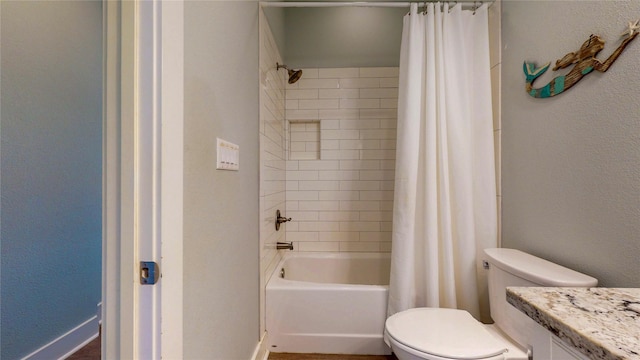 975 S Stingaree, Crystal Beach, TX 77650 - full bath with toilet, vanity, shower / bath combo with shower curtain, baseboards, and a textured wall