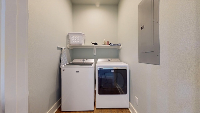 975 S Stingaree, Crystal Beach, TX 77650 - washroom featuring separate washer and dryer, electric panel, baseboards, and wood finished floors
