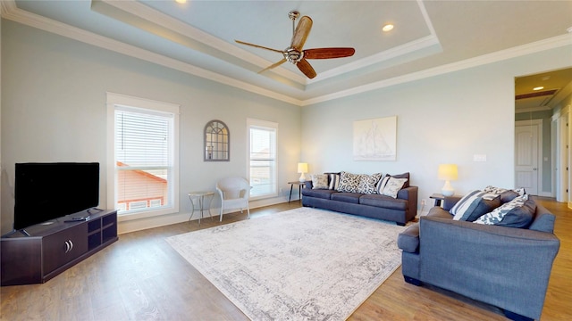 975 S Stingaree, Crystal Beach, TX 77650 - living room with a tray ceiling, a ceiling fan, light wood-style floors, crown molding, and recessed lighting