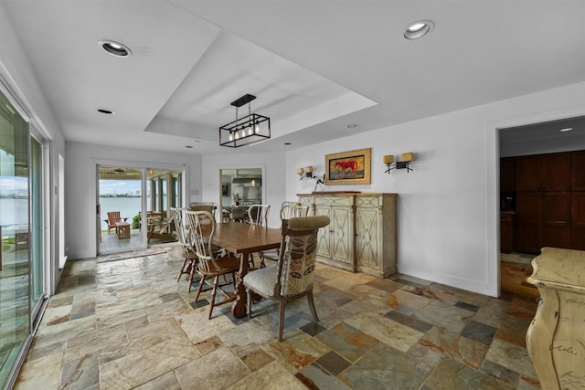 18 S Shore Dr S, Galveston, TX 77551 - dining space featuring stone tile floors, recessed lighting, baseboards, and a tray ceiling