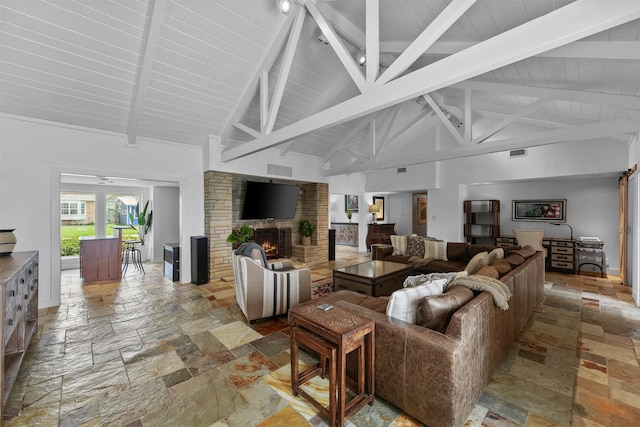 18 S Shore Dr S, Galveston, TX 77551 - living room featuring a large fireplace, beam ceiling, and stone tile floors