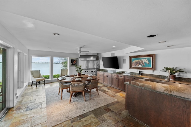 18 S Shore Dr S, Galveston, TX 77551 - dining space with stone tile floors, recessed lighting, a ceiling fan, and indoor wet bar